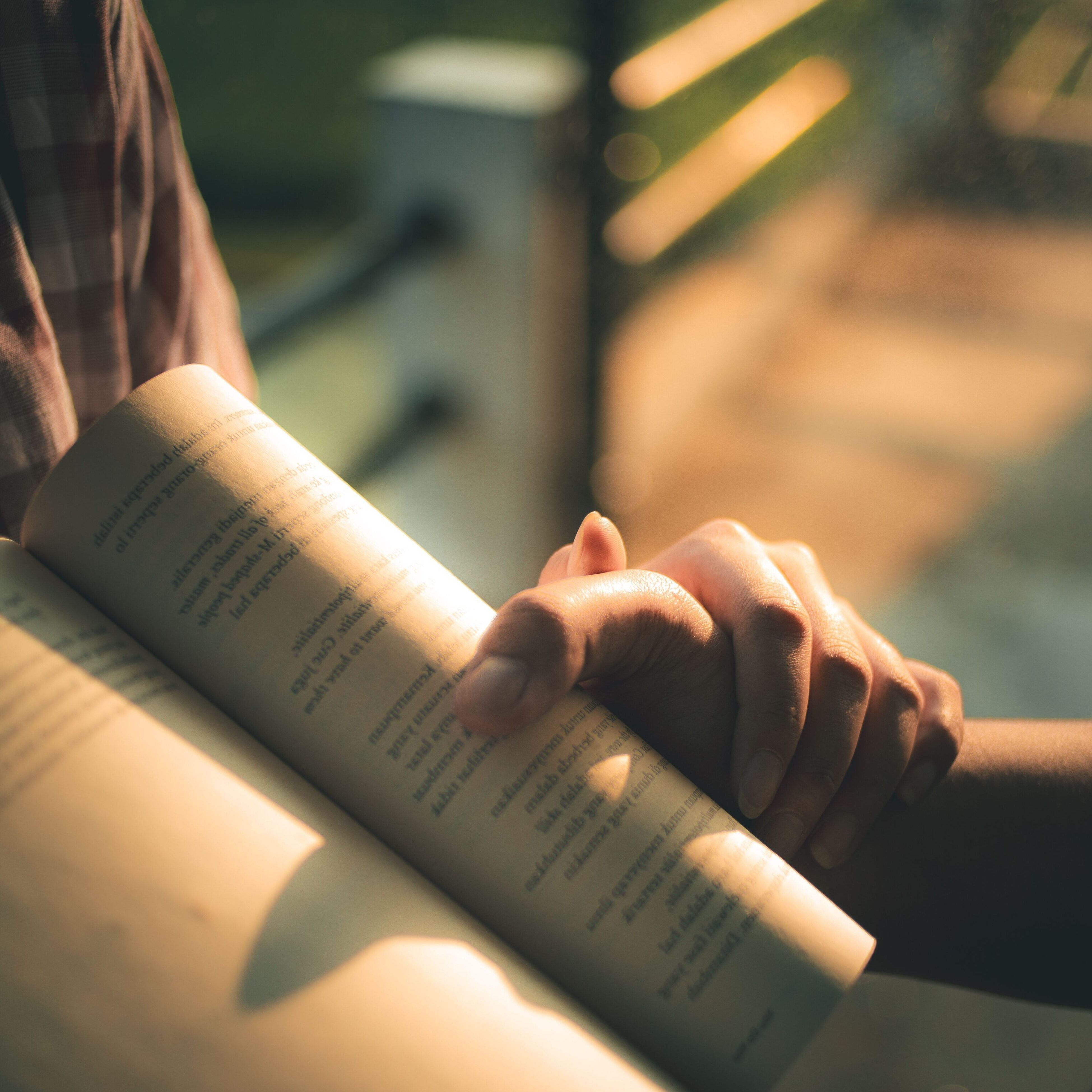 Two hands sunlight book pexels 36190390